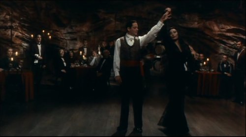 Morticia and Gomez Addams dancing.