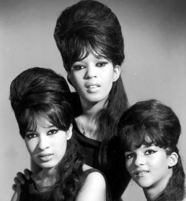 The Ronettes wearing white lipstick with a bouffant hairstyle.