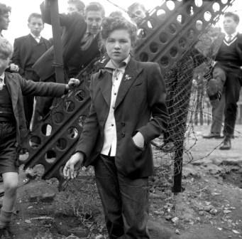 A Teddy Girl, with Teddy Boys in tow. Photo by Ken Russell.