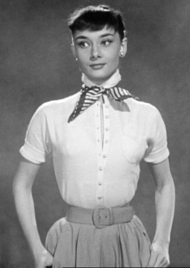 Audrey Hepburn in her screen test. The cinched waist and natural shoulders were emblematic of 1950s women's fashion.