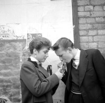 A Teddy Boy and a Teddy Girl, with cigarette and lighter. Photo by Ken Russell.