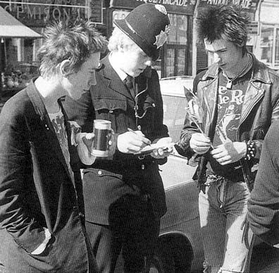 The Sex Pistols and a police officer: two types of uniform. The Sex Pistols and a police officer: two types of uniform.
