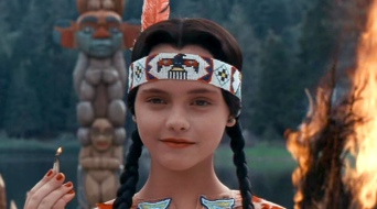 Wednesday Addams. Smiling.